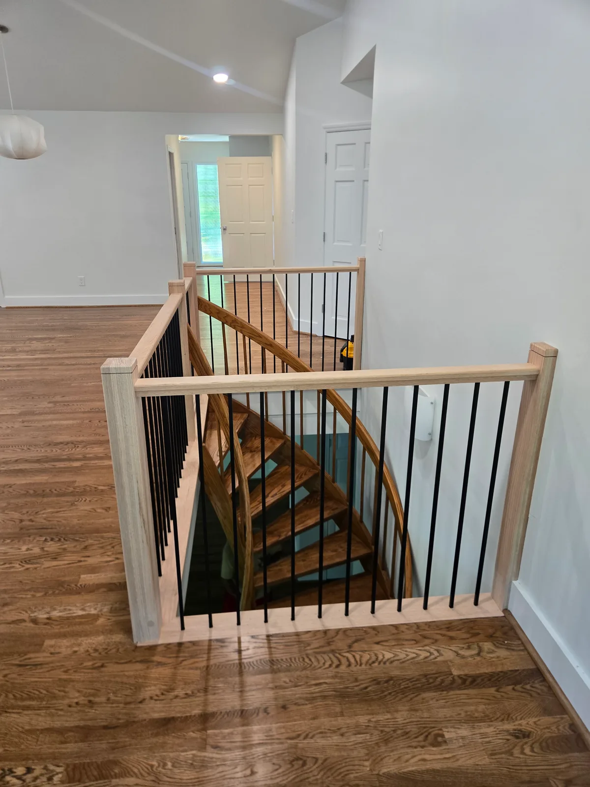 Interior stair guardrail after replacement overlooking the curved stairwell