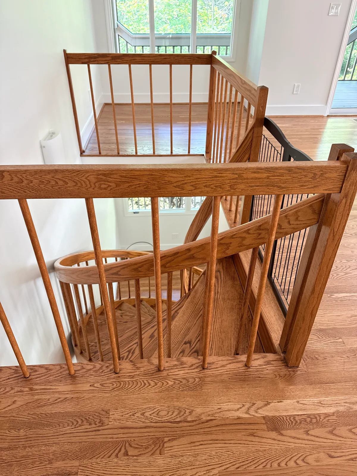 Interior wood stair guardrail before replacement overlooking the stairwell