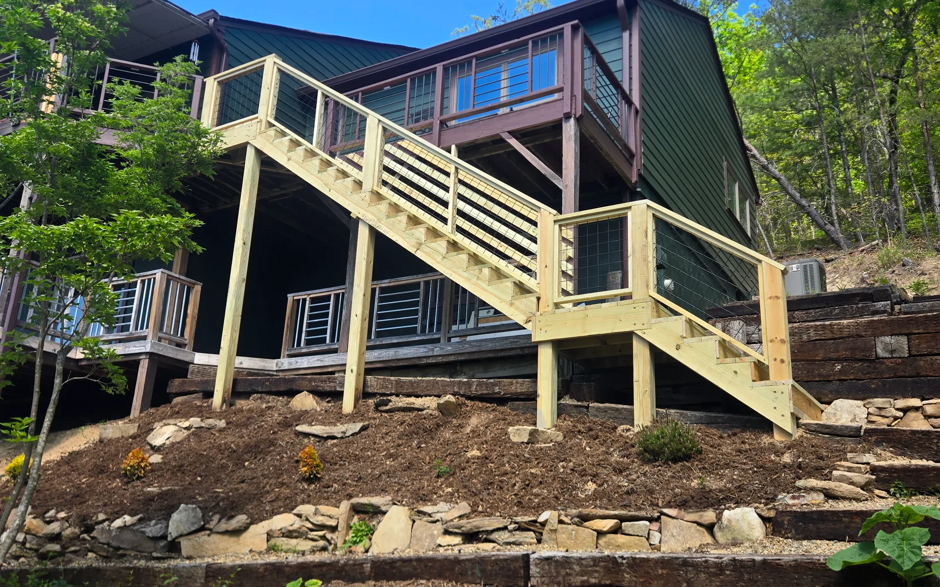 Completed outdoor hillside staircase with pressure treated railings