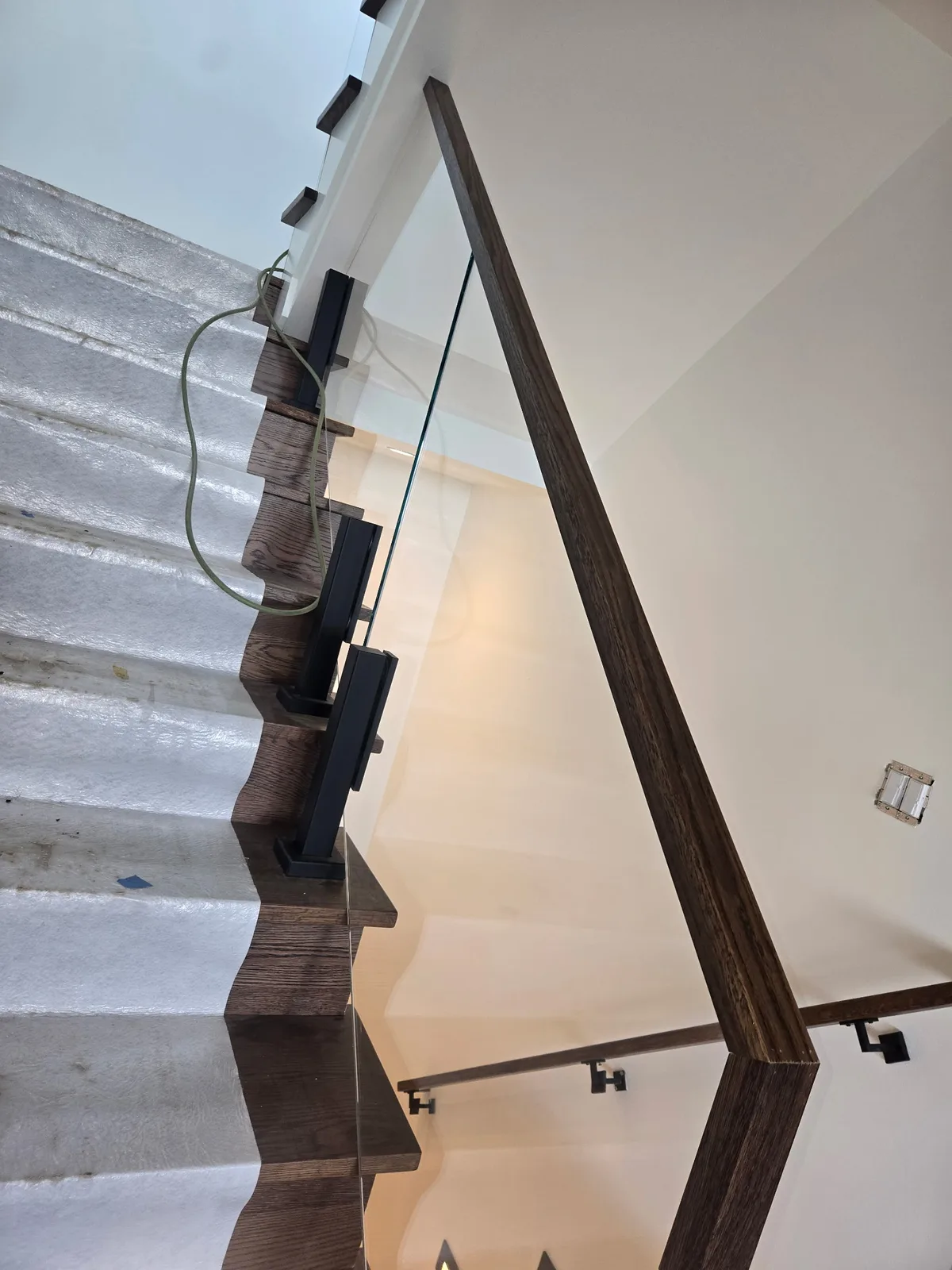 Detail view of Viewrail glass railing installed beside carpeted stairs